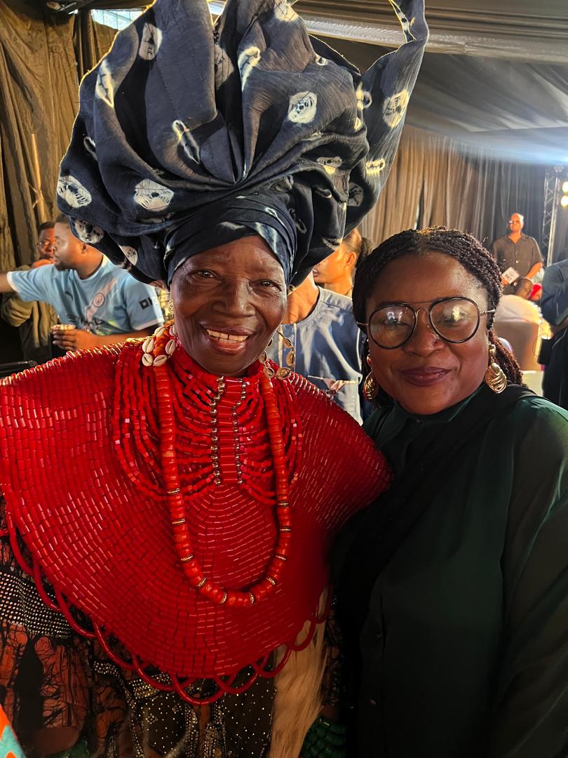 Anna Philemon Dara standing with Chief Nike Davies-Okundaye, who is wearing coral bead regalia.