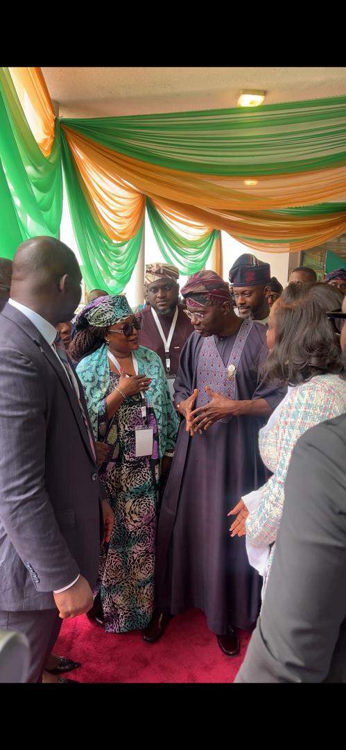 Anna Philemon Dara in discussion with officials on the sidelines of an event.